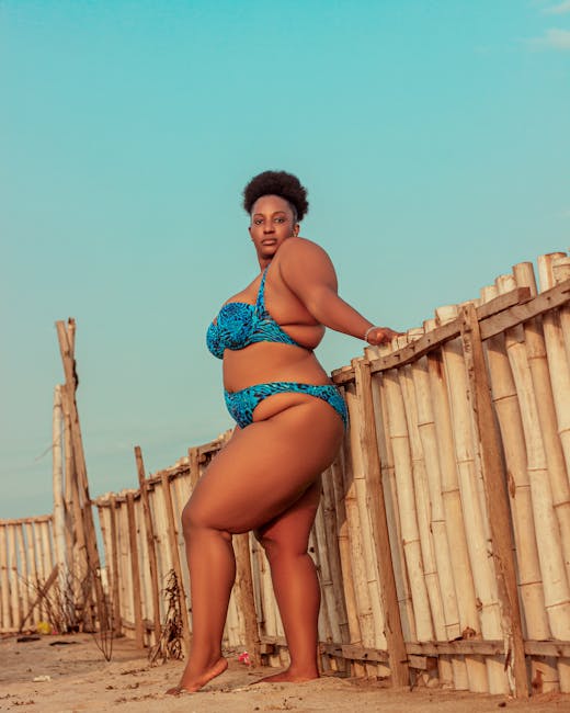 Confident plus size woman modeling bikini on beach - flattering plus size swimwear styles