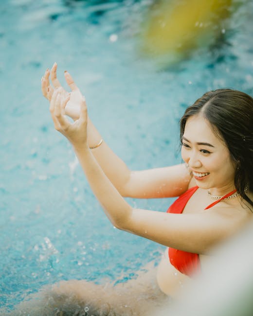 Petite woman enjoying pool in red bikini - petite swimwear guide for shorter frames