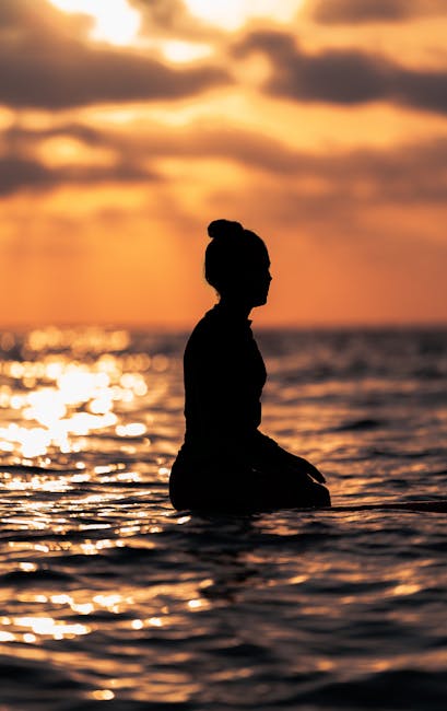 Woman silhouette at sunset beach summer solstice - summer solstice swimwear refresh ideas