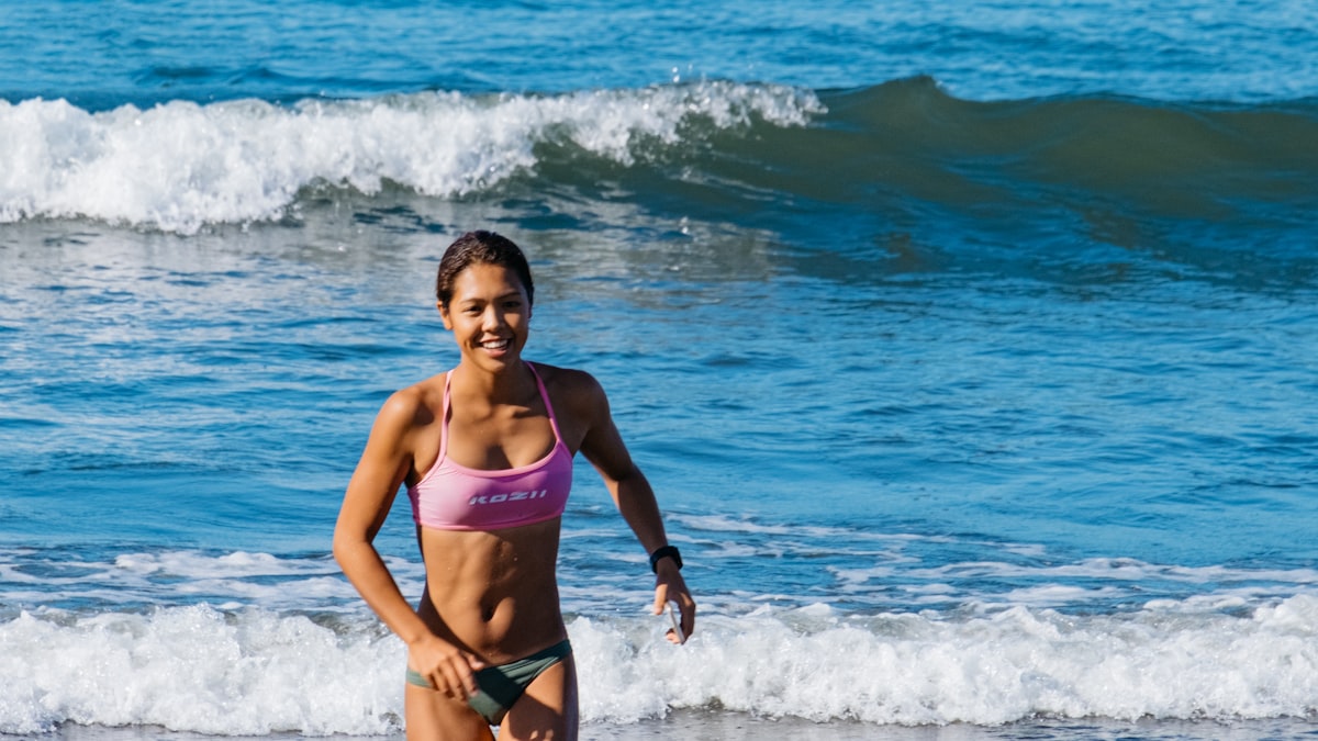 Woman walking along the seashore as a beach fitness exercise