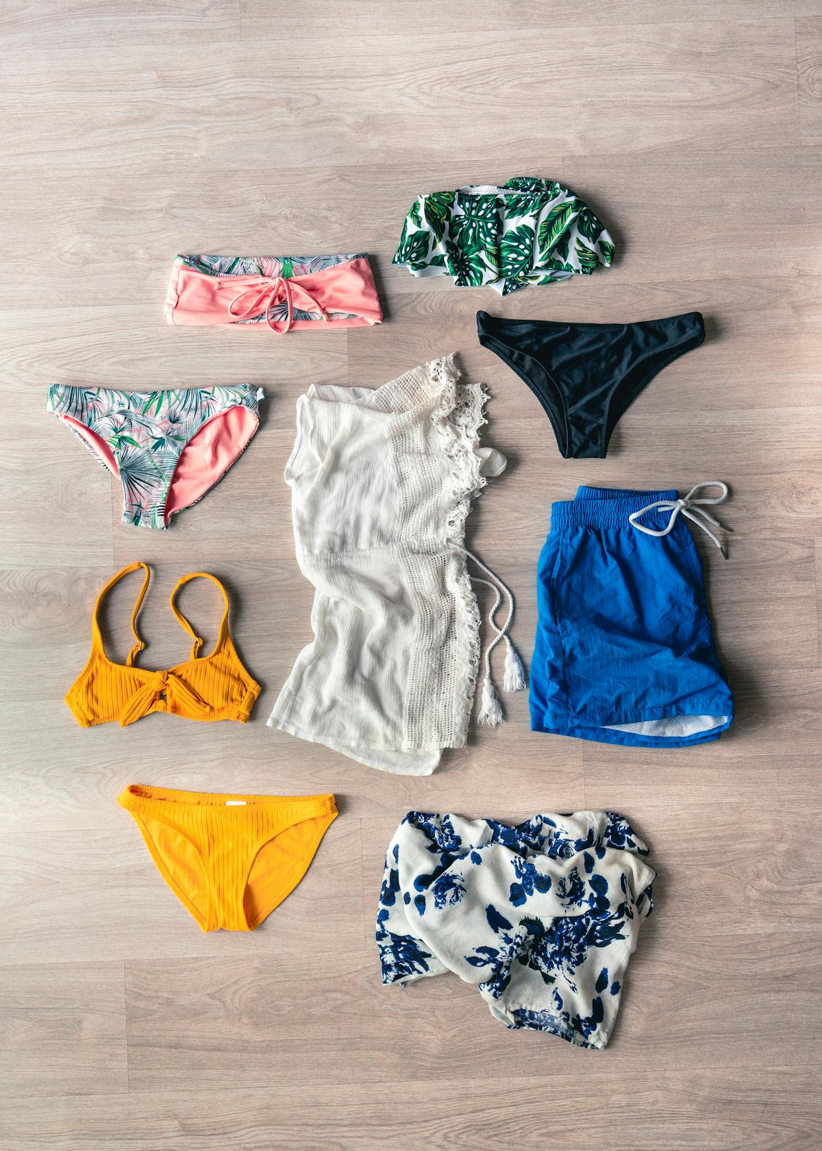 Beach vacation swimwear flatlay with bikini and summer accessories