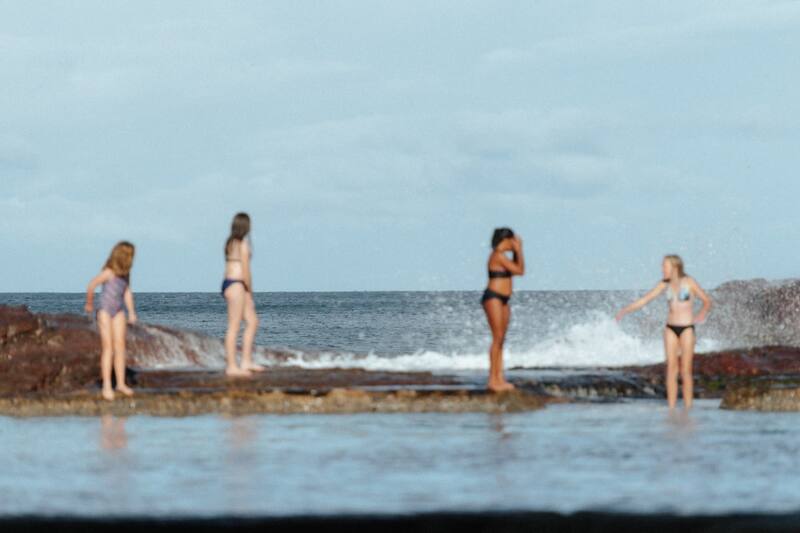 Group of diverse women celebrating body positivity at the beach