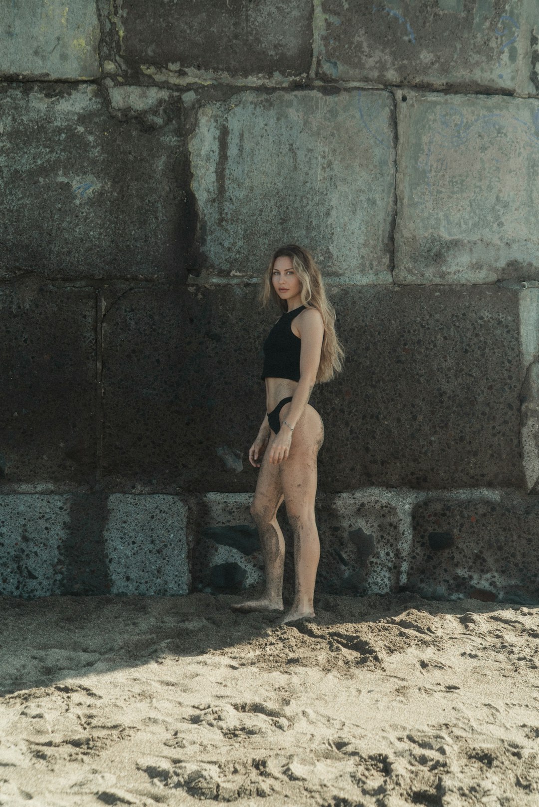 Earth tone swimwear on the beach showcasing neutral color swimsuit trends for 2026