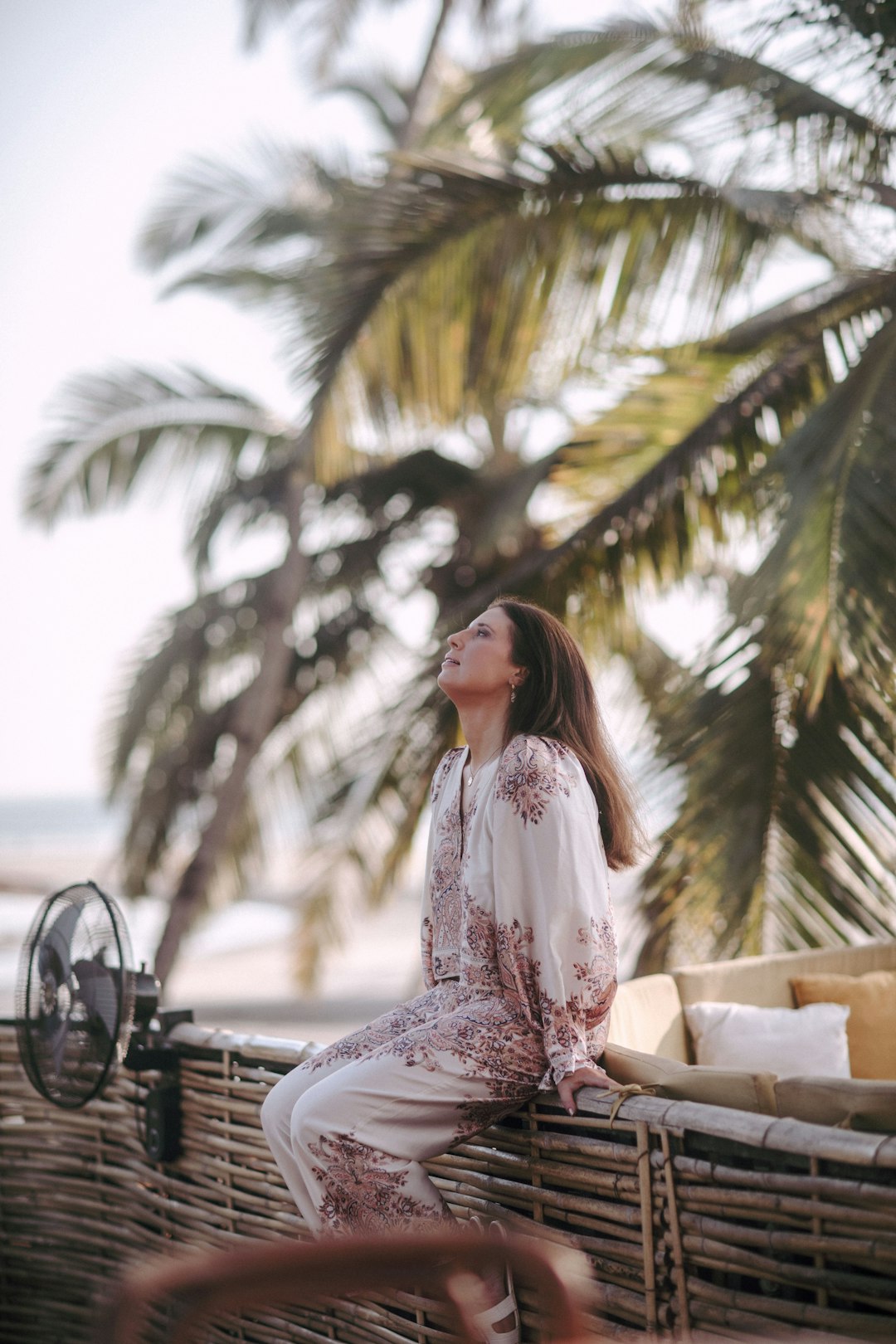 Tropical resort beach outfit under palm trees - relaxed vacation fashion