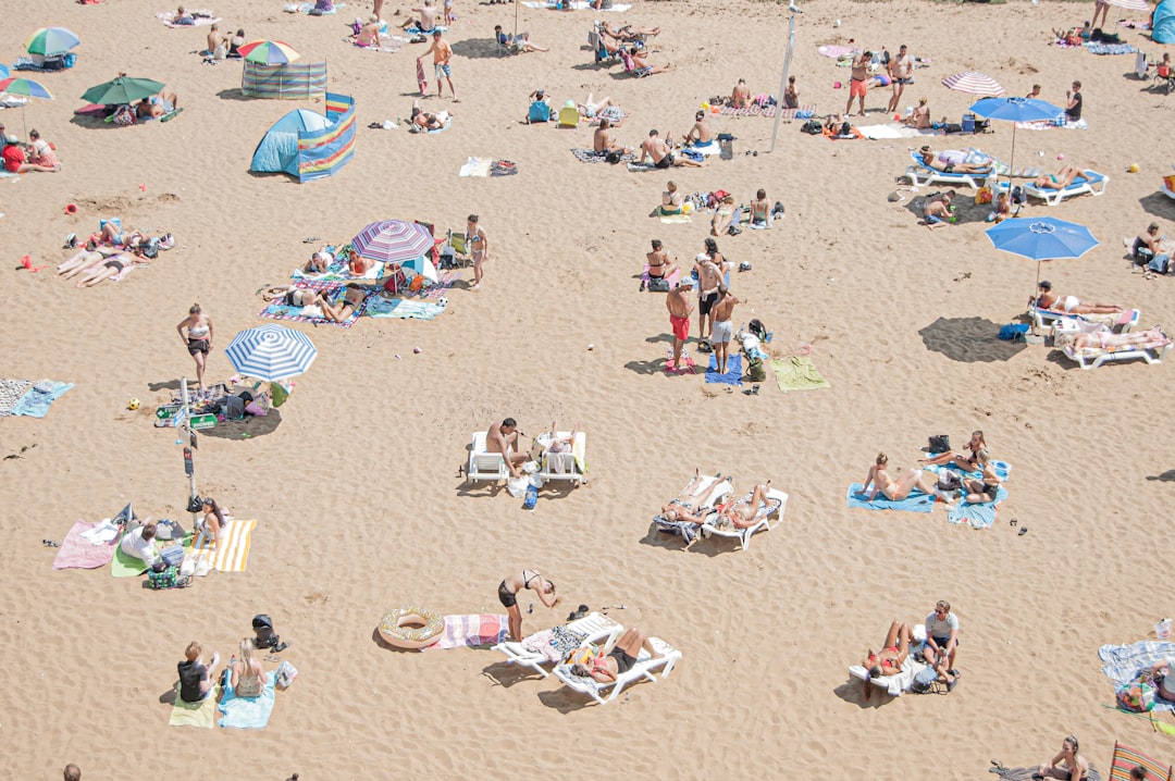 People sunbathing and enjoying beach activities in inclusive swimwear