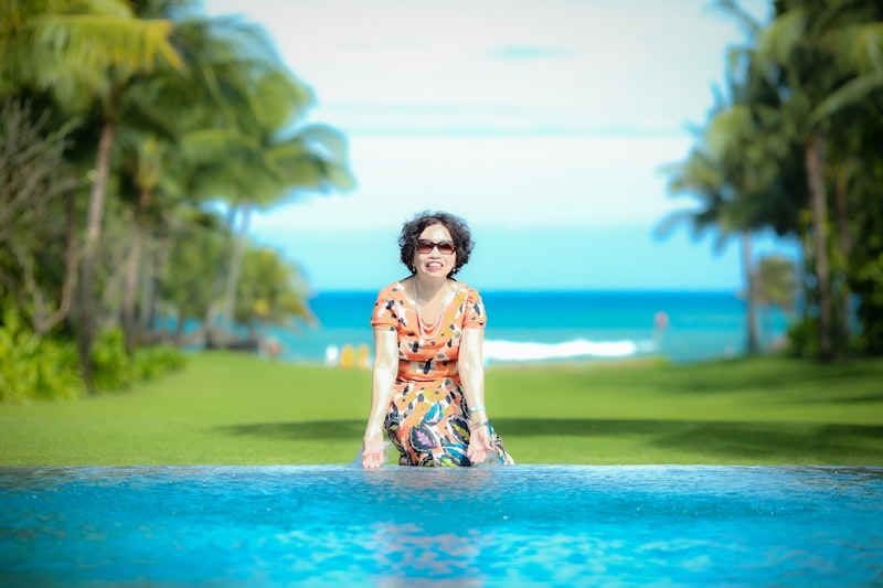 Woman relaxing poolside at tropical resort in summer swimwear cover-up