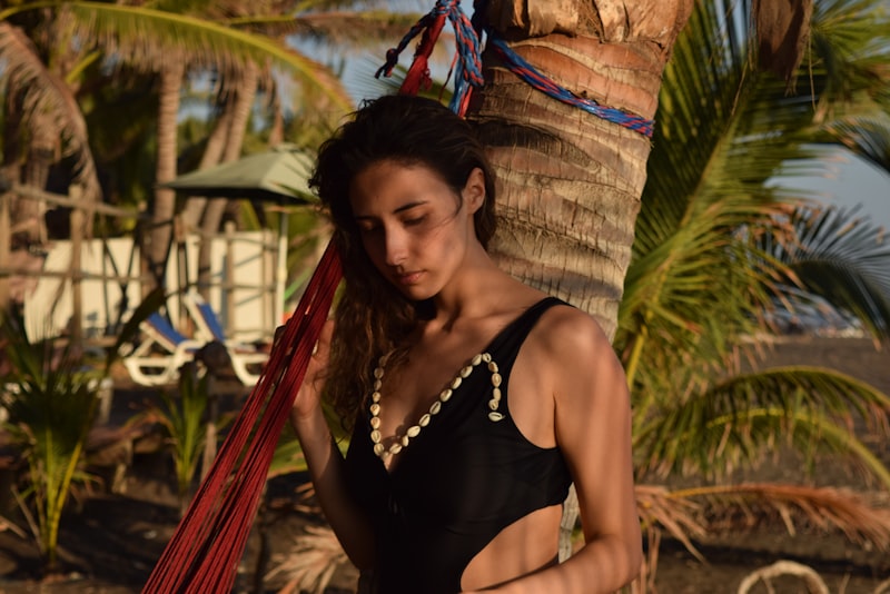 Woman relaxing in hammock at tropical beach resort during summer vacation