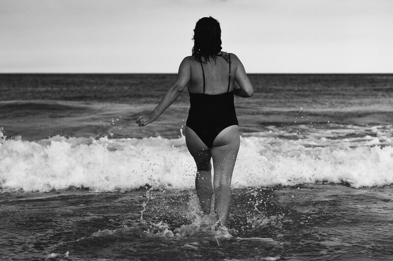 body positive beach confidence in a colorful bikini at sunset