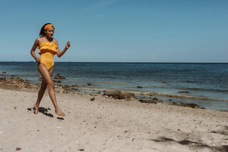 one shoulder swimwear confident walk on the beach