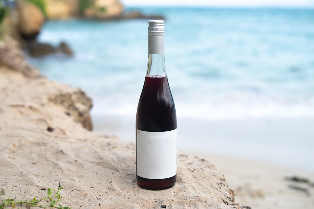 A generic wine bottle placed on a beach sand cliff