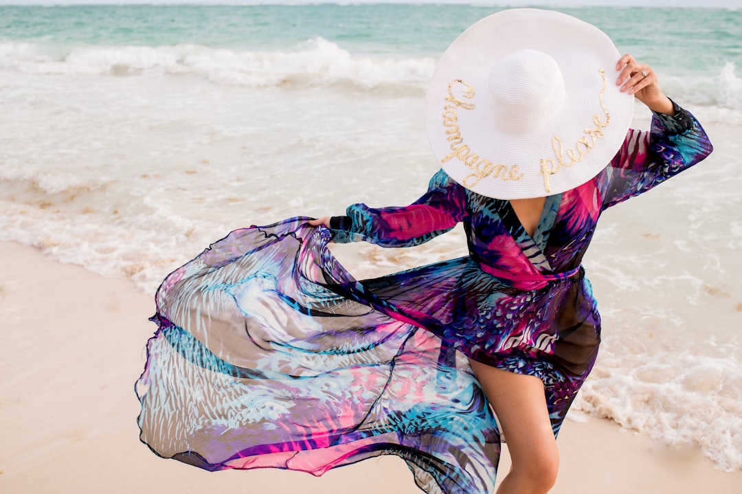 Beautiful girl wearing a flowy colorful dress and hat with 