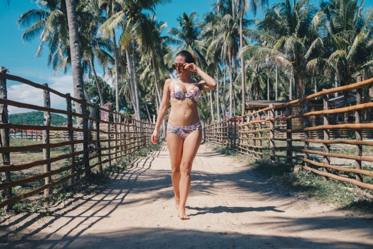 woman sanding on pathway wearing bikini during daytime