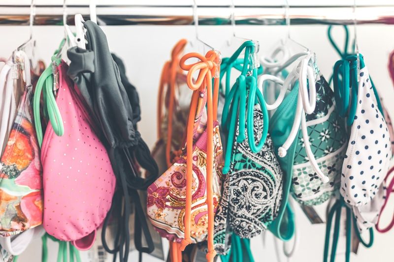 Bikinis hanging to dry after pool wash to prevent chlorine swimwear damage