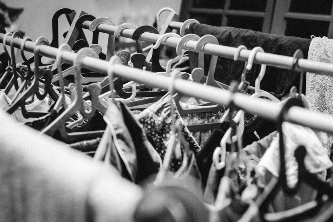 a bunch of clothes hanging on a rail