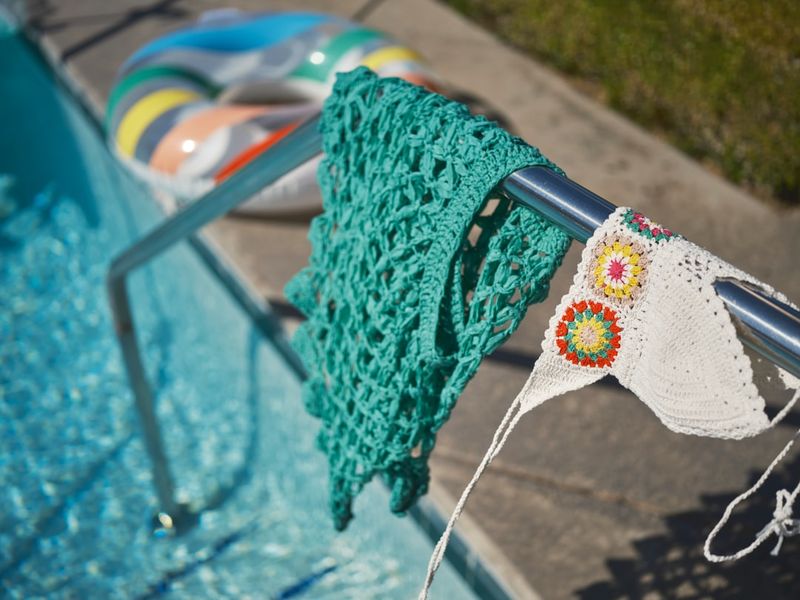 Swimwear by pool showing chlorine damage prevention rinsing routine