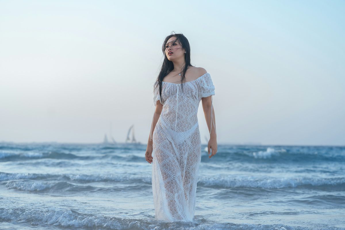 Bikini cover ups best styles 2026 — woman in white lace cover up at beach