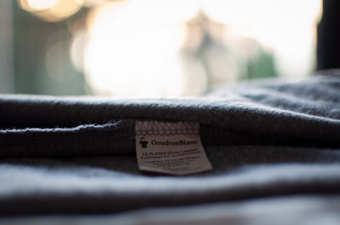 The composition label of a GoudronBlanc T-shirt - Photo taken in an artistic way - 100% organic cotton GoudronBlanc is a sust