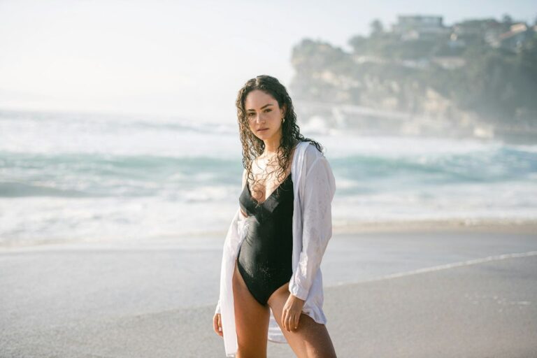 Tankini tops best styles 2026 — woman on beach in tankini swimwear