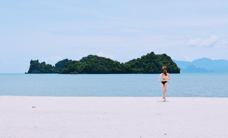 High cut brazilian bikini bottom on a long sandy shoreline