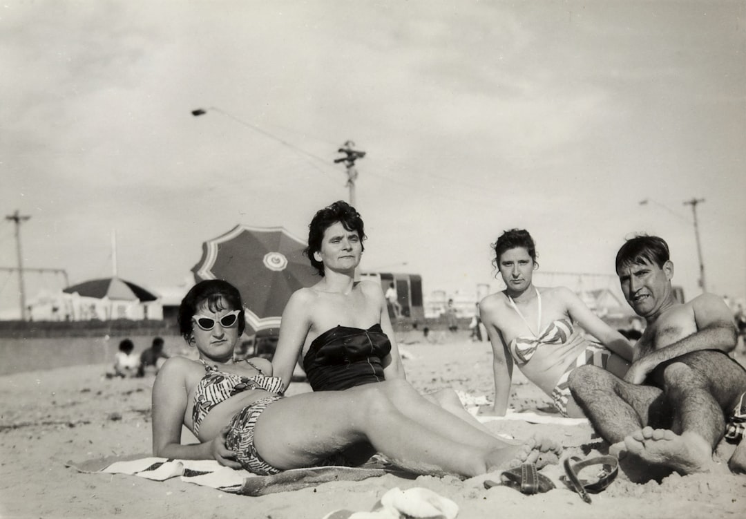 Three Women & Man Lying on Beach, Albert Park Beach, late 1950s