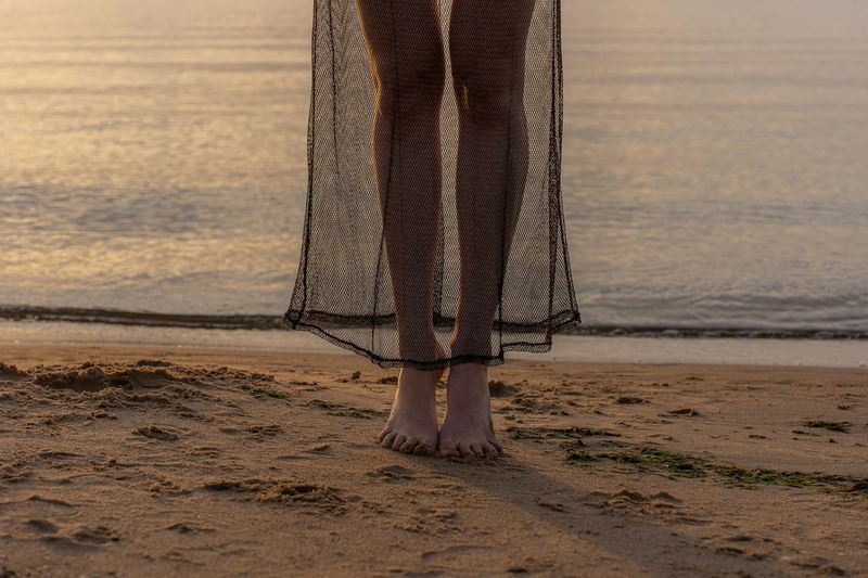 Sheer mesh bikini cover up dress at sunset beach