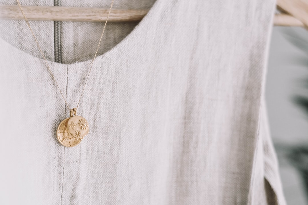 Gold necklace on a beige linen dress