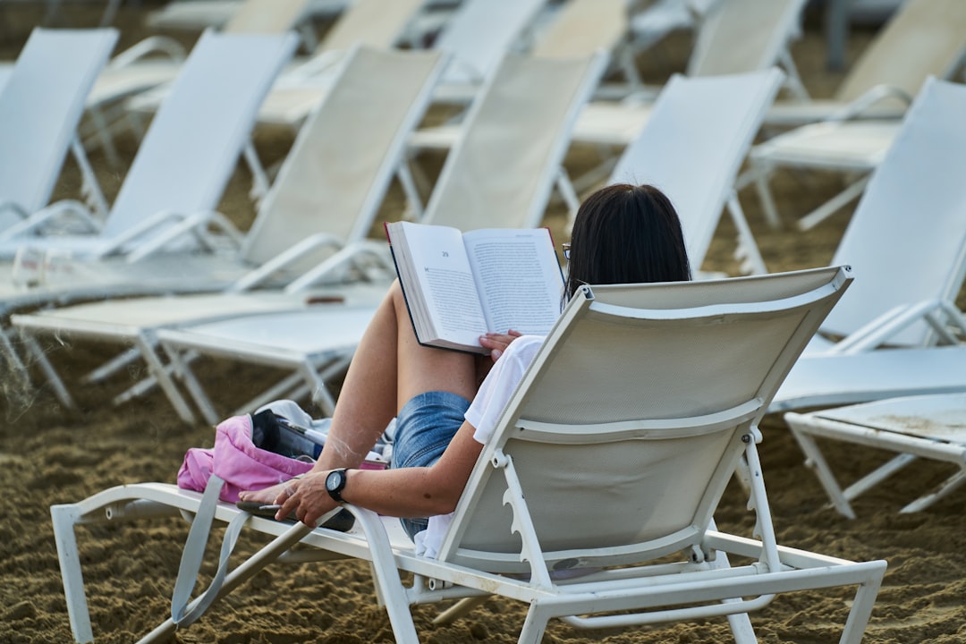 woman reading a book on the beach