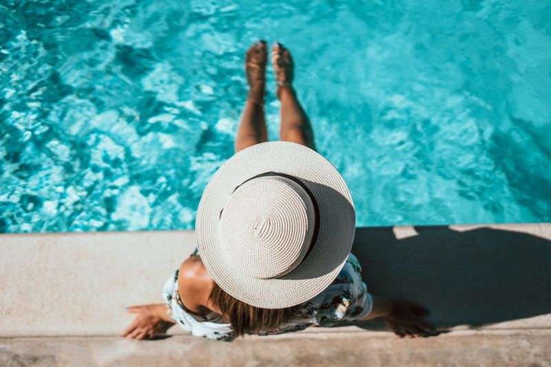 Poolside elegance in a sun hat for swimsuits over 50