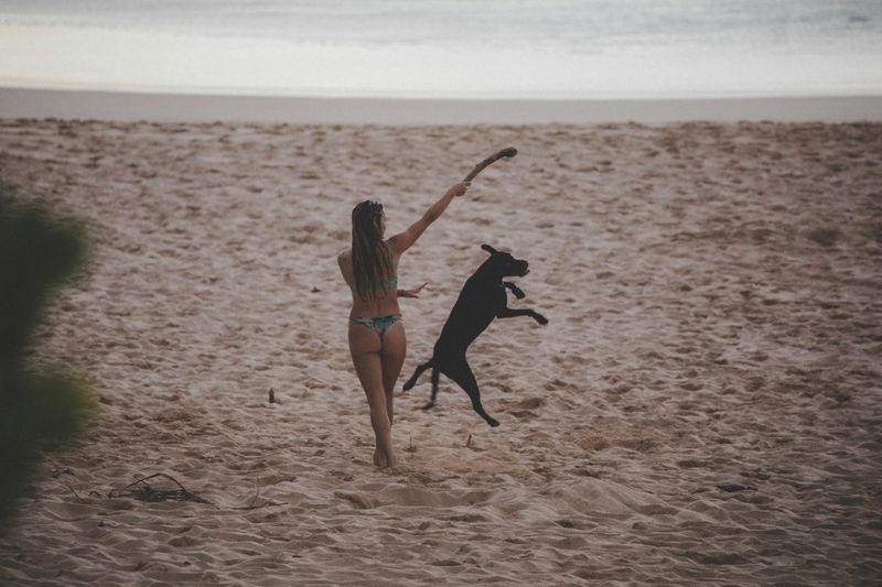 Triangle bikini lifestyle shot — beach day with classic two-piece swimwear