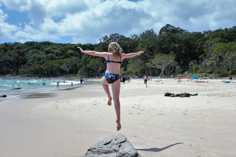 best tummy control bikini wearer jumping in confidence Australia beach