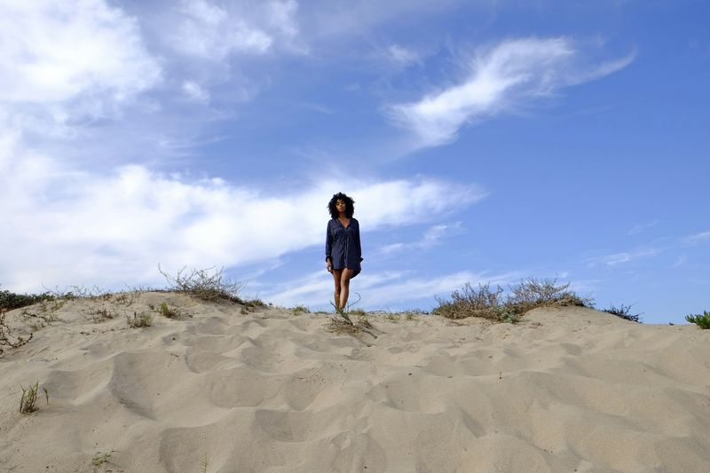 Oversized white beach shirt as a bikini cover up on sand dune