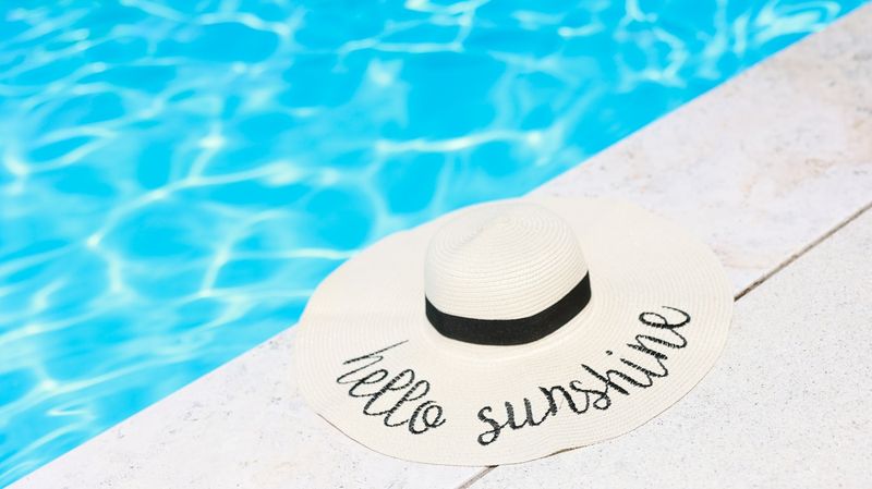 sun hat by the pool ready for a full day at the beach