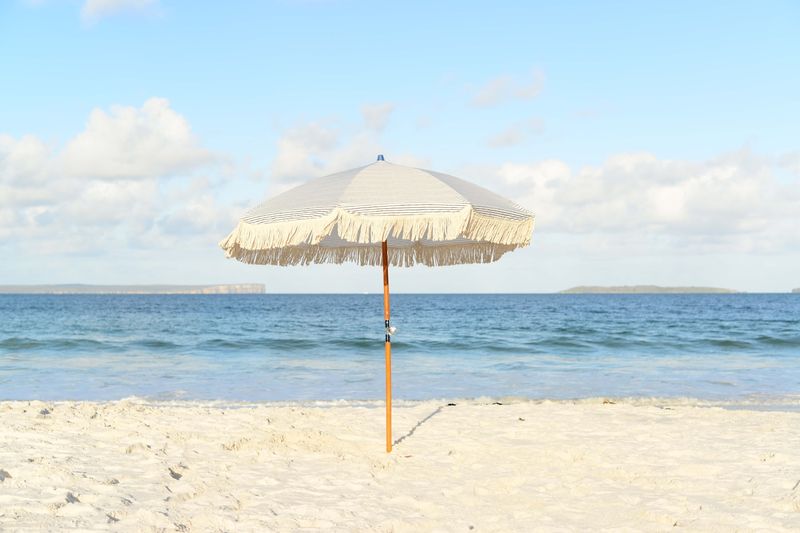 beach umbrella providing shade on a sunny afternoon during a perfect beach day