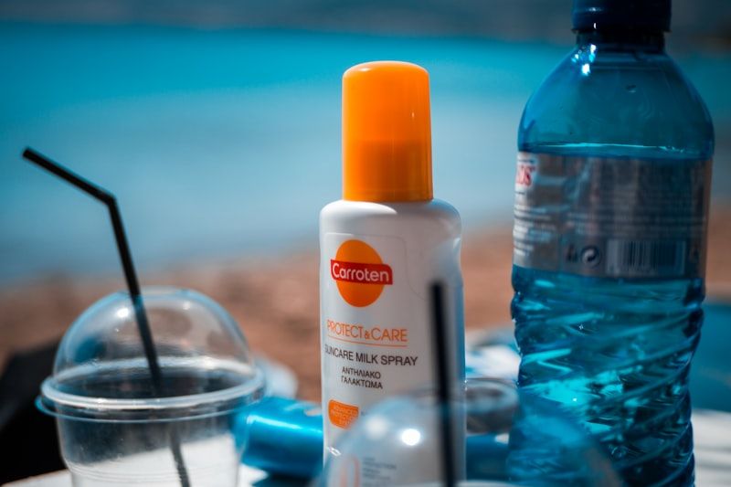 sunscreen spray bottle at beach for sun protection