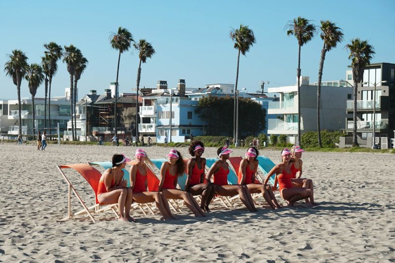 diverse women wearing bright swimsuit colors on the beach