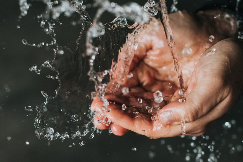 Hand washing a swimsuit in cool water to make it last