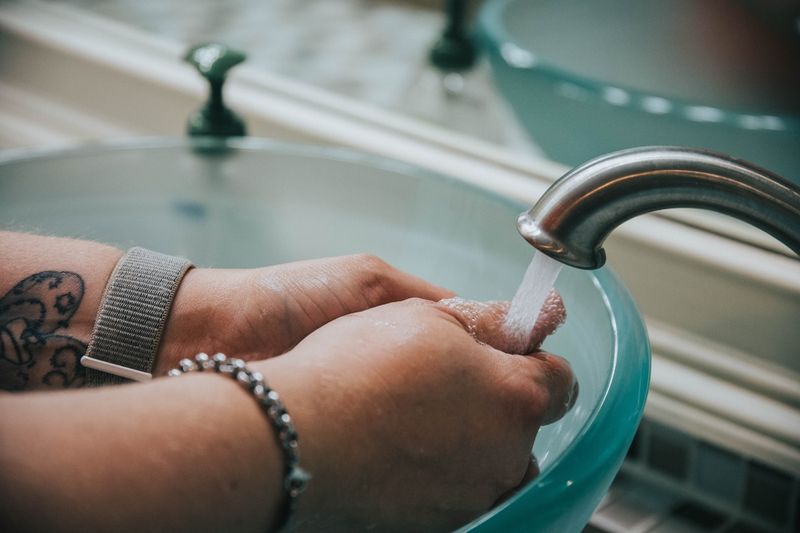 Hand washing a swimsuit in cold water to revive old bikinis