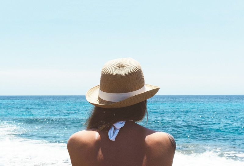 Woman in animal print swimwear on the beach showing off summer style