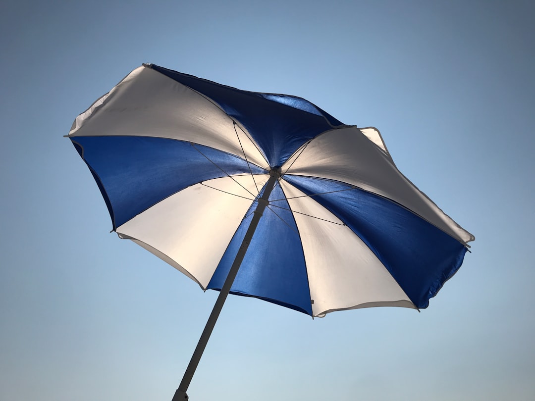 Beach umbrella back lit by the sun on the beach in Southampton, NY. 