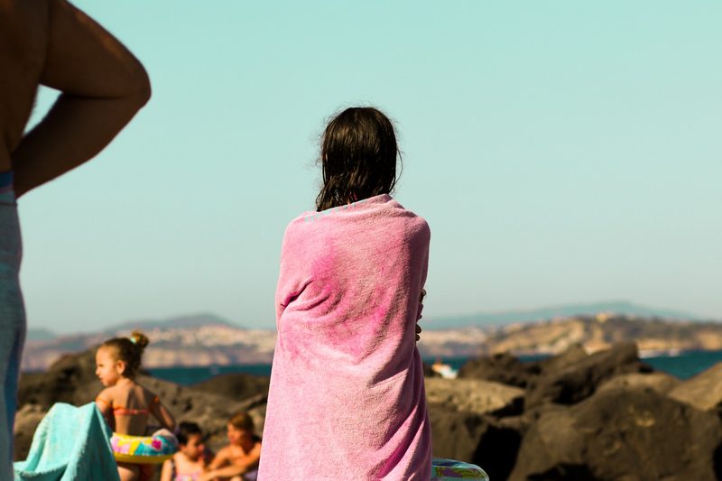 Woman caring for swimsuit fabric at the beach
