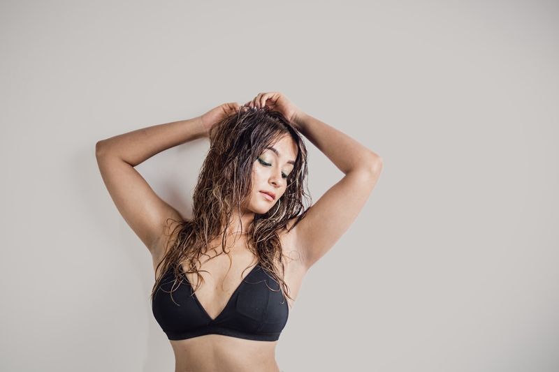 Swimsuit top showing adjustable straps and triangle cups for support