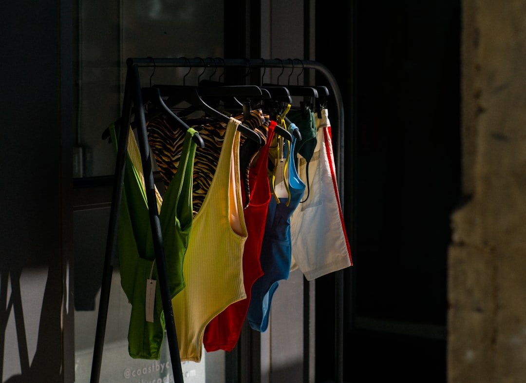 Colorful clothes hang on a rack outside.
