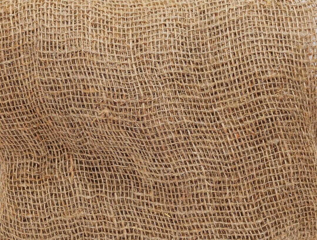 Horizontal textured background with coarse mesh fabric. Rough, coarse-cell texture fabric. Texture background with fabric (bu