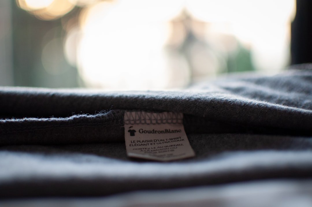 The composition label of a GoudronBlanc T-shirt - Photo taken in an artistic way - 100% organic cotton GoudronBlanc is a sust