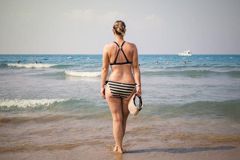 bikini bottom styles lifestyle — women enjoying summer beach day
