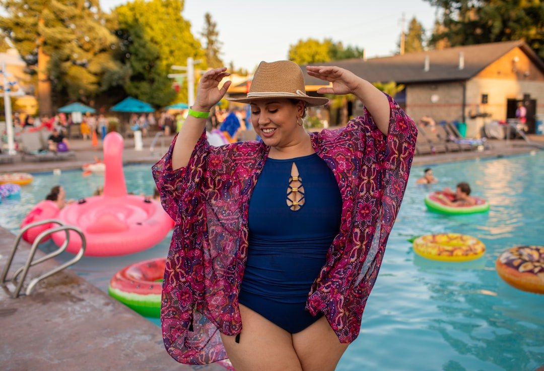 Happy plus size woman at a pool party