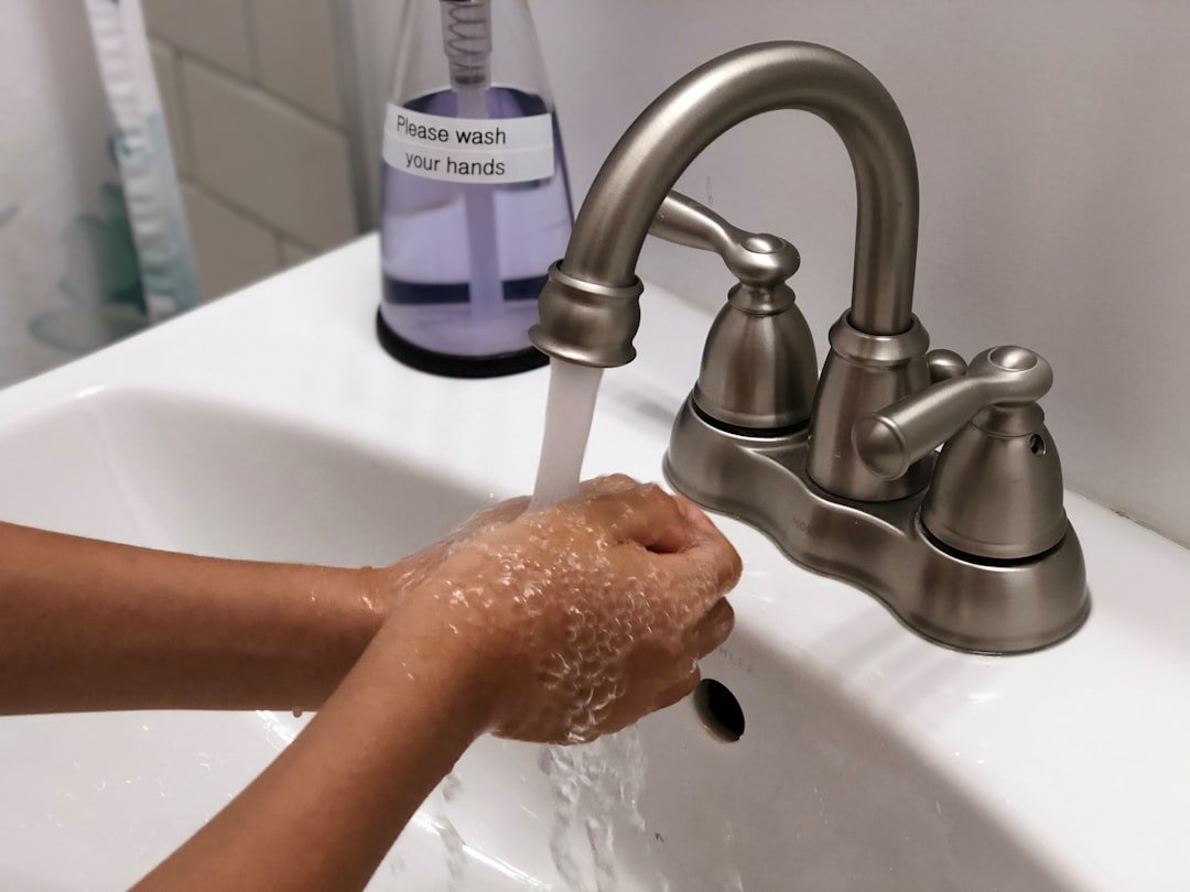 Photo of child's hands washing at sink