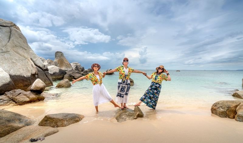 women wearing summer beach shorts outfits at tropical shoreline