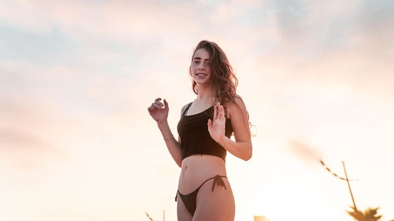 Dark bikini top paired with a bright bottom to shift visual weight down