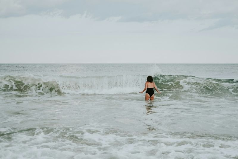 swimmer in the ocean wearing sun protection after applying reef safe sunscreen